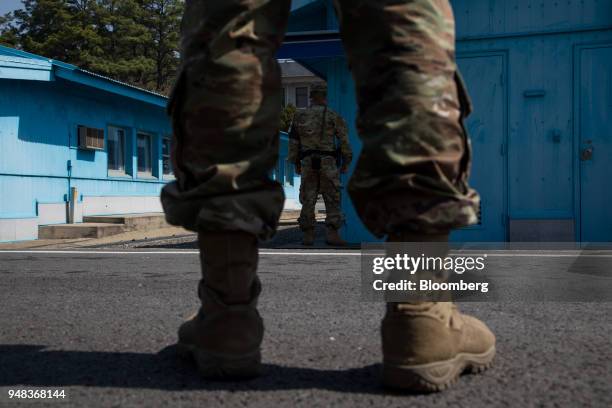 Soldiers stand guard next to the United Nations Command Military Armistice Commission conference buildings at the truce village of Panmunjom in the...