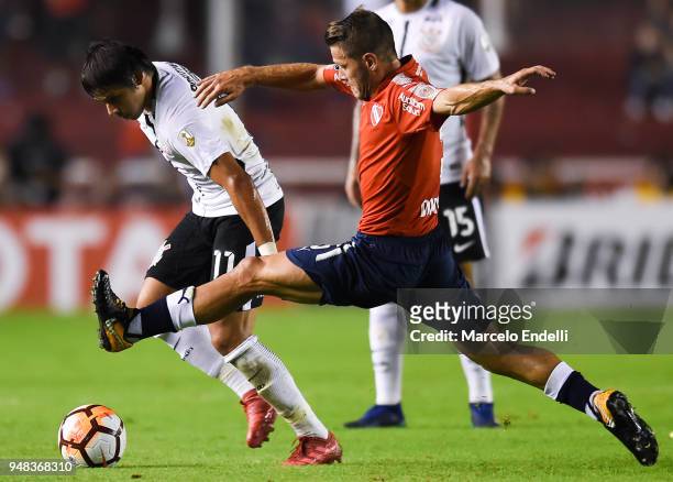 Angel Romero of Corinthians fights for ball with Nicolas Domingo of Independiente during a Group 7 match between Independiente and Corinthians as...
