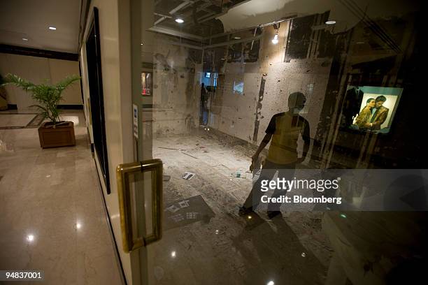 Worker stands in a shop being renovated inside the Trident hotel prior to the official re-opening in Mumbai, India, on Saturday, Dec. 20, 2008. A...