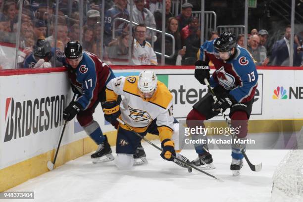 Alexander Kerfoot and Tyson Jost of the Colorado Avalanche fight for the puck against Nick Bonino of the Nashville Predators in Game Four of the...
