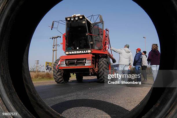 Group of farmers stop an agriculture machine at a cross roads outside Rojas, Buenos Aires province, Argentina, on Friday, May 9, 2008. A standoff...