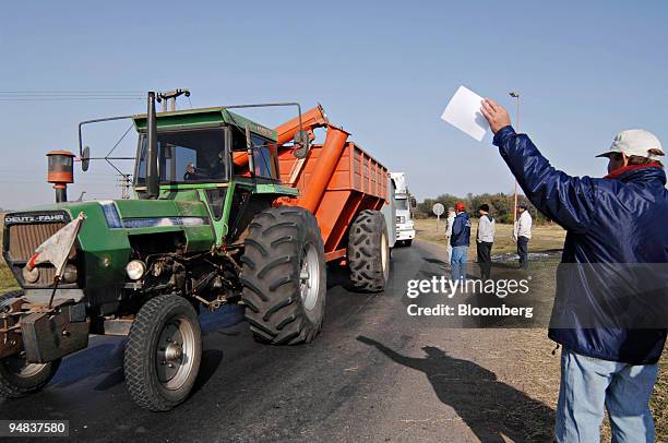 Group of farmers stop a tractor at a cross roads outside Rojas, Buenos Aires province, Argentina, on Friday, May 9, 2008. A standoff between...