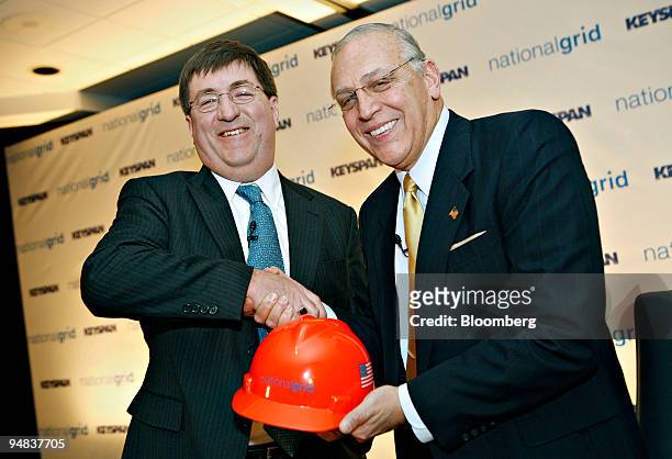 Michael Jesanis, president and COO of National Grid USA, left, shakes hands with Robert Catell , chief executive officer of KeySpan Corp. During a...