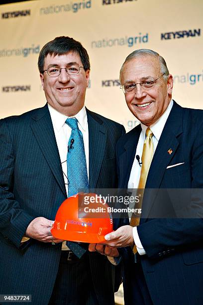 Michael Jesanis, president and COO of National Grid USA, left, shakes hands with Robert Catell , chief executive officer of KeySpan Corp. During a...