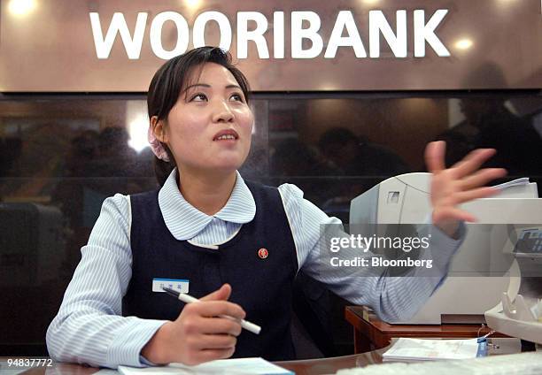 North Korean teller answers questions at a Woori Bank business center in the Kaesong Industrial Complex in North Korea Monday, February 27, 2006. The...