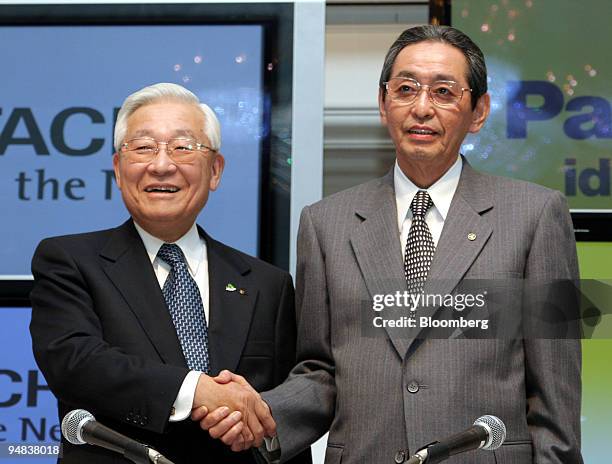 Etsuhiko Shoyama, Hitachi Ltd. President and chief executive, left, and Matsushita Electric Industrial Co., Ltd. President Kunio Nakamura shake hands...