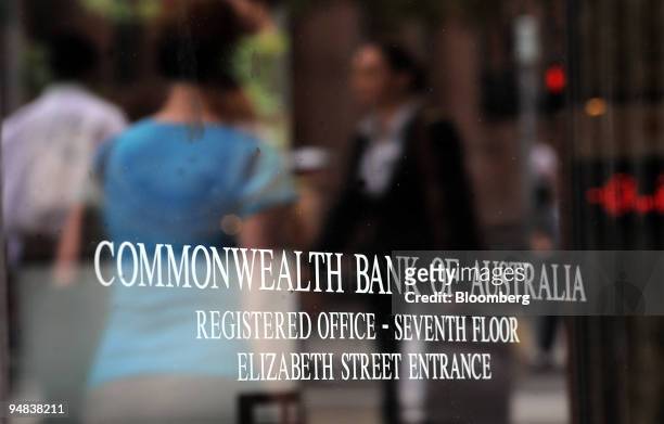 Pedestrians are reflected in a Commonwealth Bank of Australia sign in Sydney, Australia, on Wednesday, Dec. 17, 2008. Commonwealth Bank of Australia,...