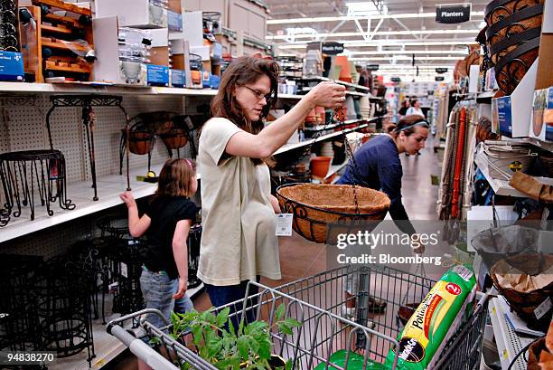 Merrie Steiner, of Feasterville, Pennsylvania, shops for a plant hanger inside a Wal-Mart store in Trevose, Pennsylvania, U.S., on Thursday, May 8,...