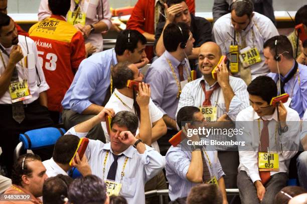 Traders work at the Brazilian Bolsa de Mercadorias e Futuros, or Brazilian Mercantile and Futures Exchange , in Sao Paulo, Brazil, on Monday, Oct. 6,...