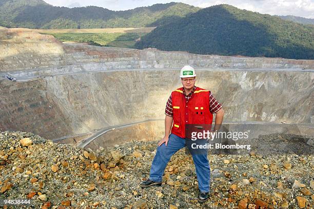 Phil Brumit, general manager of PT Newmont Nusa Tenggara's Batu Hijau copper mining operation, poses on the edge of the company's mining pit on the...