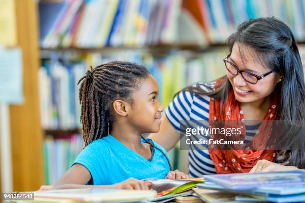reading together in the library - kids reading in classroom stock pictures, royalty-free photos & images
