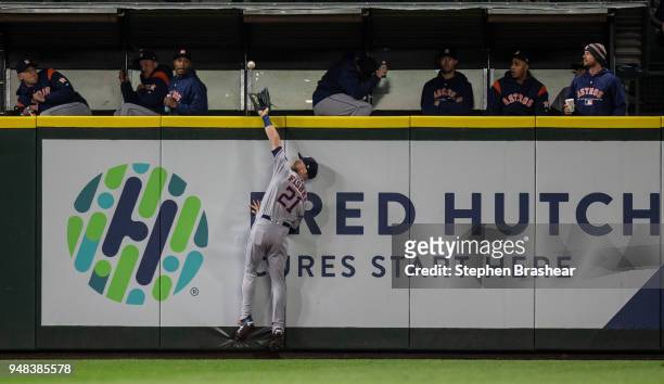 Leftfielder Derek Fisher of the Houston Astros catches a fly ball at the wall hit by Jean Segura of the Seattle Mariners during the fifth inning of a...