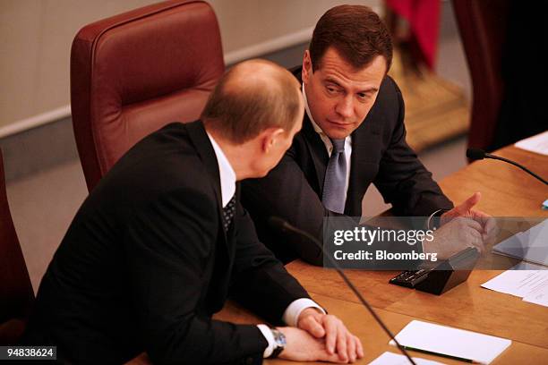 Dmitry Medvedev, Russian president, right, and Vladimir Putin, the newly elected prime minister, speak in the Russian Duma in Moscow, Russia, on...