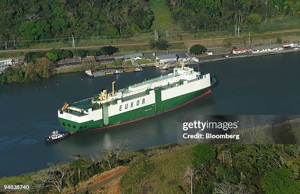 The Swedish cargo ship Traviata, with its load of cars, is pushed by a tugboat to Gatun Lake after crossing Miraflores Locks in the Pacific end of...