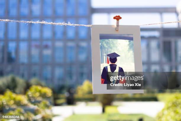 ph.d student graduation picture hanging on a string - alumni bildbanksfoton och bilder