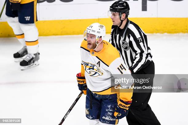Mattias Ekholm of the Nashville Predators reacts to being called for slashing after being hit hard to the ice on a penalty by Gabriel Landeskog of...