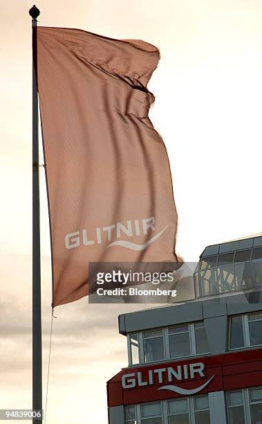 The Glitnir Bank company flag flies from a flagpole at the headquarters in Reykjavik, Iceland, on Wednesday, Oct. 1, 2008. Arni Einarsson looks out...