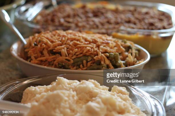 mashed potatoes, green bean casseroles and sweet potato side dishes await to be served - mashed sweet potato stock-fotos und bilder