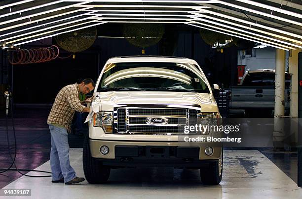 Kent Bailey wipes down a 2009 Ford F-150 pickup truck in the metal and paint repair department at the Kansas City Assembly Plant in Claycomo,...