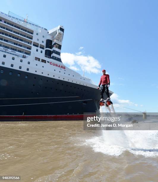 Jay St John flies close to Queen Mary 2 on July 05, 2015 in Liverpool, England. Champion flyboarder Jay St John donned a Cunard Bell Boy's uniform to...