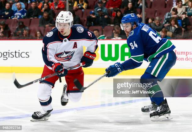 Tyler Motte of the Vancouver Canucks checks Artemi Panarin of the Columbus Blue Jackets during their NHL game at Rogers Arena March 31, 2018 in...