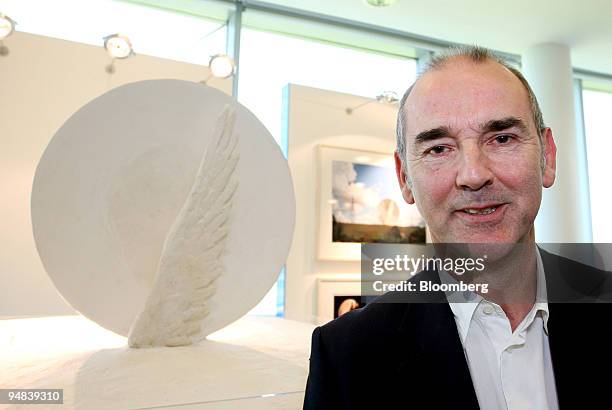 Artist Christopher Le Brun poses next to a model of his shortlisted proposal of a wing and disc, at Ebbsfleet International Station, Kent, U.K., on...