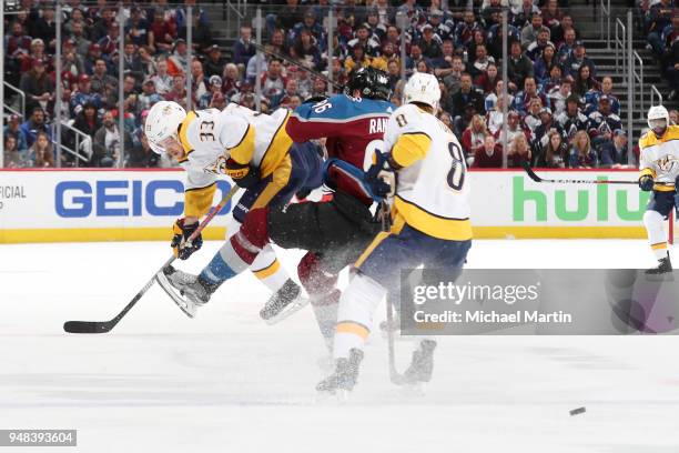 Mikko Rantanen of the Colorado Avalanche is checked by Kyle Turris and Viktor Arvidsson of the Nashville Predators in Game Four of the Western...