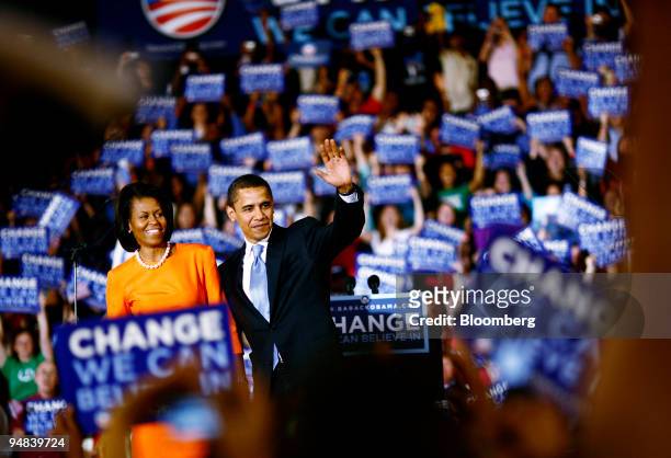 Barack Obama, U.S. Senator from Illinois and Democratic presidential candidate, and his wife Michelle, wave to a crowd at a primary night event in...