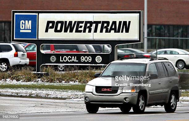 Vehicle drives outside the General Motors Powertrain Plant in Warren, Michigan, U.S., on Friday, Dec. 12, 2008. General Motors Corp. And Chrysler...