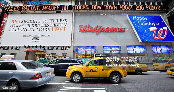 The Dow Jones ticker in Times Square displays news of the failed auto-rescue bill in New York, U.S., on Friday, Dec. 12, 2008. U.S. Stocks, the...