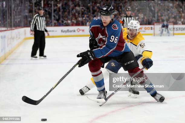 Mikko Rantanen of the Colorado Avalanche fights for control of the puck against Austin Watson of the Nashville Predatorsin Game Four of the Western...