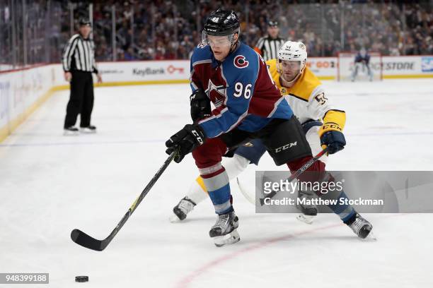 Mikko Rantanen of the Colorado Avalanche fights for control of the puck against Austin Watson of the Nashville Predatorsin Game Four of the Western...