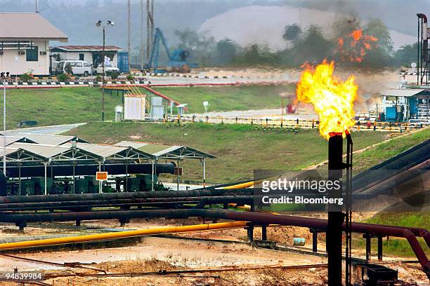 Gas is burnt off at one of PT Caltex Pacific Indonesia's gathering stations in the Minas oil field north of Pekanbaru, Sumatra, on Wednesday,...