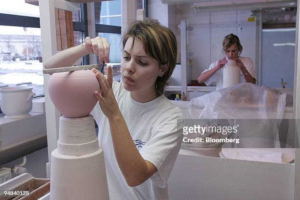 Workers hand sculpt pieces of porcelain in the workshops of Herend Porcelain Manufactory Ltd., in Herend, Hungary, Friday, December 2, 2005.