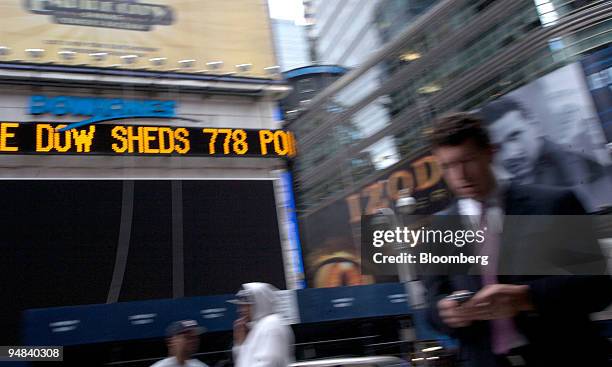 The Dow Jones ticker in Times Square displays news about the stock market in New York, U.S., on Monday, Sept. 29, 2008. U.S. Stocks plunged and the...
