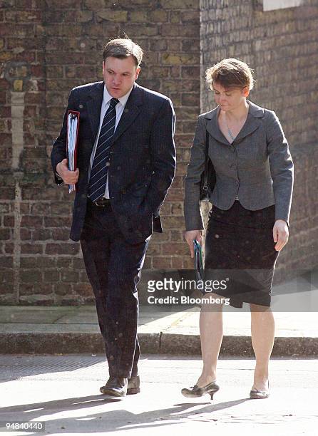 Ed Balls, U.K. Education secretary, left, and his wife Yvette Cooper, chief secretary to the Treasury, arrive for the weekly cabinet meeting at...