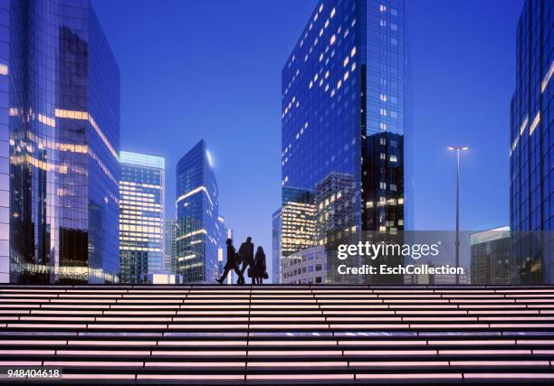 early morning with business people arriving at modern business district - blue corporate imagens e fotografias de stock