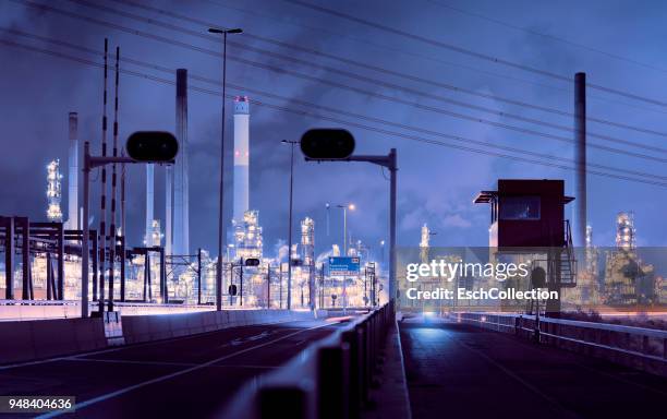 panorama of illuminated oil refinery in rotterdam at dawn - rotterdam stock pictures, royalty-free photos & images