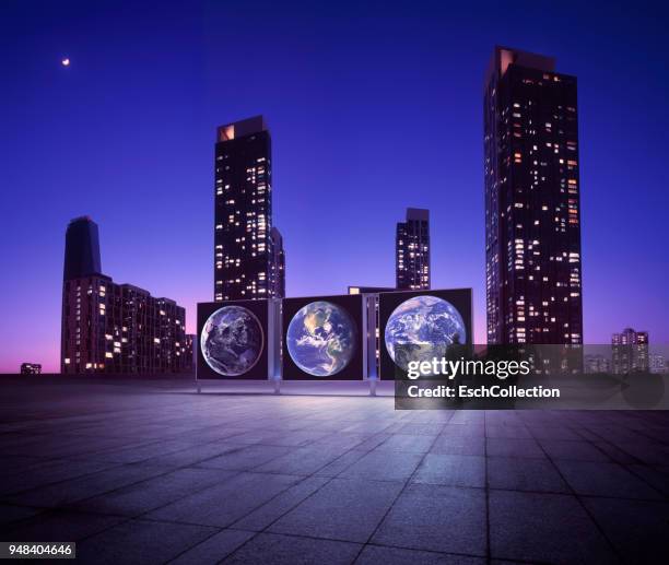illuminated cityscape with man looking at earth expo - edificio de eventos - fotografias e filmes do acervo