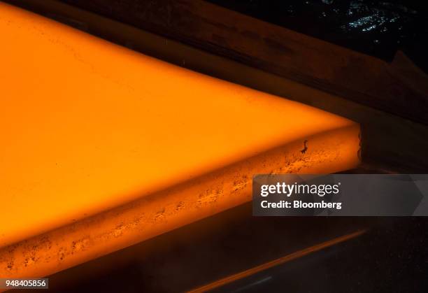 Hot steel slab moves along a conveyor of a plate mill at the Nippon Steel & Sumitomo Metal Corp. Plant in Kashima, Ibaraki, Japan, on Wednesday,...