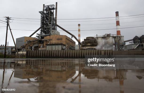 Blast furnace is reflected in water at the Nippon Steel & Sumitomo Metal Corp. Plant in Kashima, Ibaraki, Japan, on Wednesday, April 18, 2018....