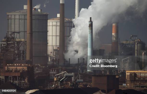 Emissions rise from chimneys at the Nippon Steel & Sumitomo Metal Corp. Plant stands in Kashima, Ibaraki, Japan, on Wednesday, April 18, 2018....