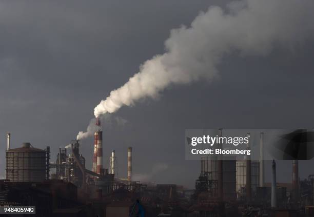 Emissions rise from chimneys at the Nippon Steel & Sumitomo Metal Corp. Plant stands in Kashima, Ibaraki, Japan, on Wednesday, April 18, 2018....