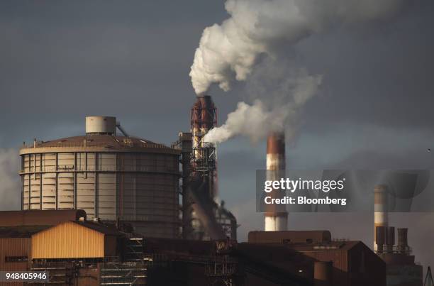 Emissions rise from chimneys at the Nippon Steel & Sumitomo Metal Corp. Plant stands in Kashima, Ibaraki, Japan, on Wednesday, April 18, 2018....