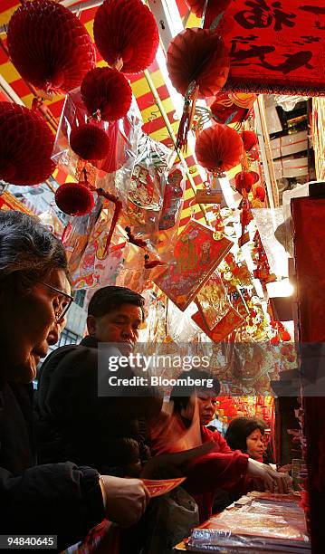 Hong Kong residents shop for Lunar New Year decorations in a local shop Wednesday, February 2, 2005. Chinese communities from Singapore to San...