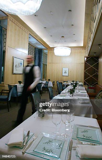 Waiter passes through the dining room of the Capital restaurant in London, U.K., Thursday, February 23, 2006. Eric Chavot's restaurant, the Capital,...