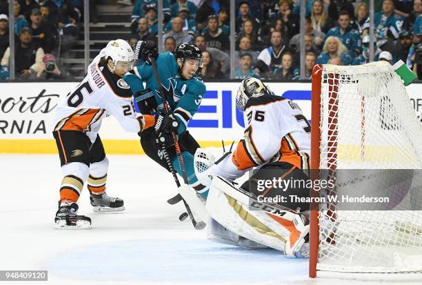 Goalie John Gibson and Brandon Montour of the Anaheim Ducks defend the goal against Logan Couture of the San Jose Sharks during the second period in...