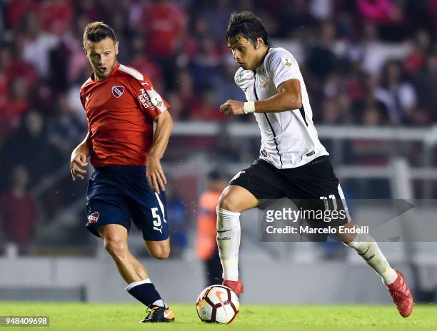 Angel Romero of Corinthians drives the ball under pressure of Nicolas Domingo of Independiente during a Group 7 match bewteen Independiente and...