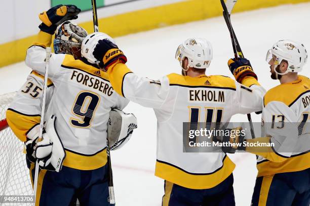 Goalie Pekka Rinne of the Nashville Predators is congratulated by teammates Filip Forsberg, Mattias Elkholm and Nick Bonino after a 3-2 win against...