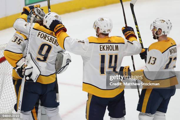 Goalie Pekka Rinne of the Nashville Predators is congratulated by teammates Filip Forsberg, Mattias Elkholm and Nick Bonino after a 3-2 win against...